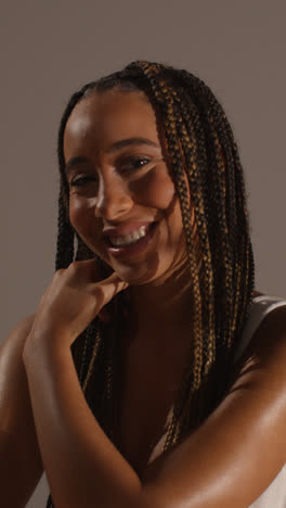 Studio-Beauty-Shot-Of-Smiling-Young-Woman-With-Long-Braided-Hair-Against-Neutral-Background-3